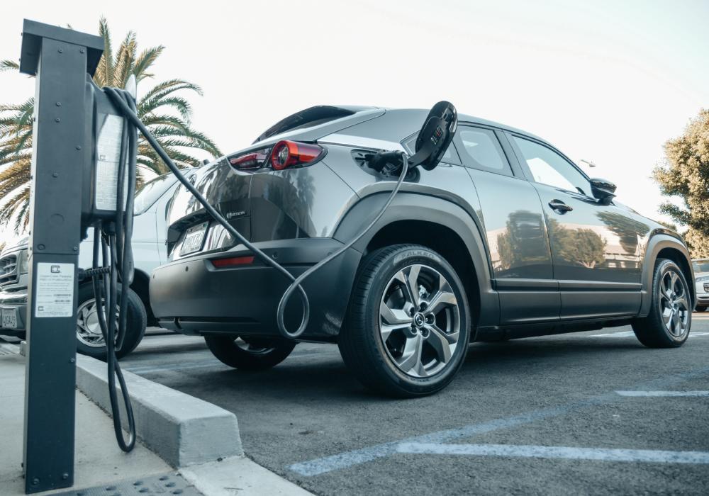 Electric vehicle charging at a commercial parking space.