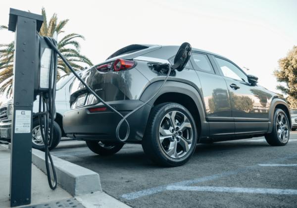 Electric vehicle charging at a commercial parking space.